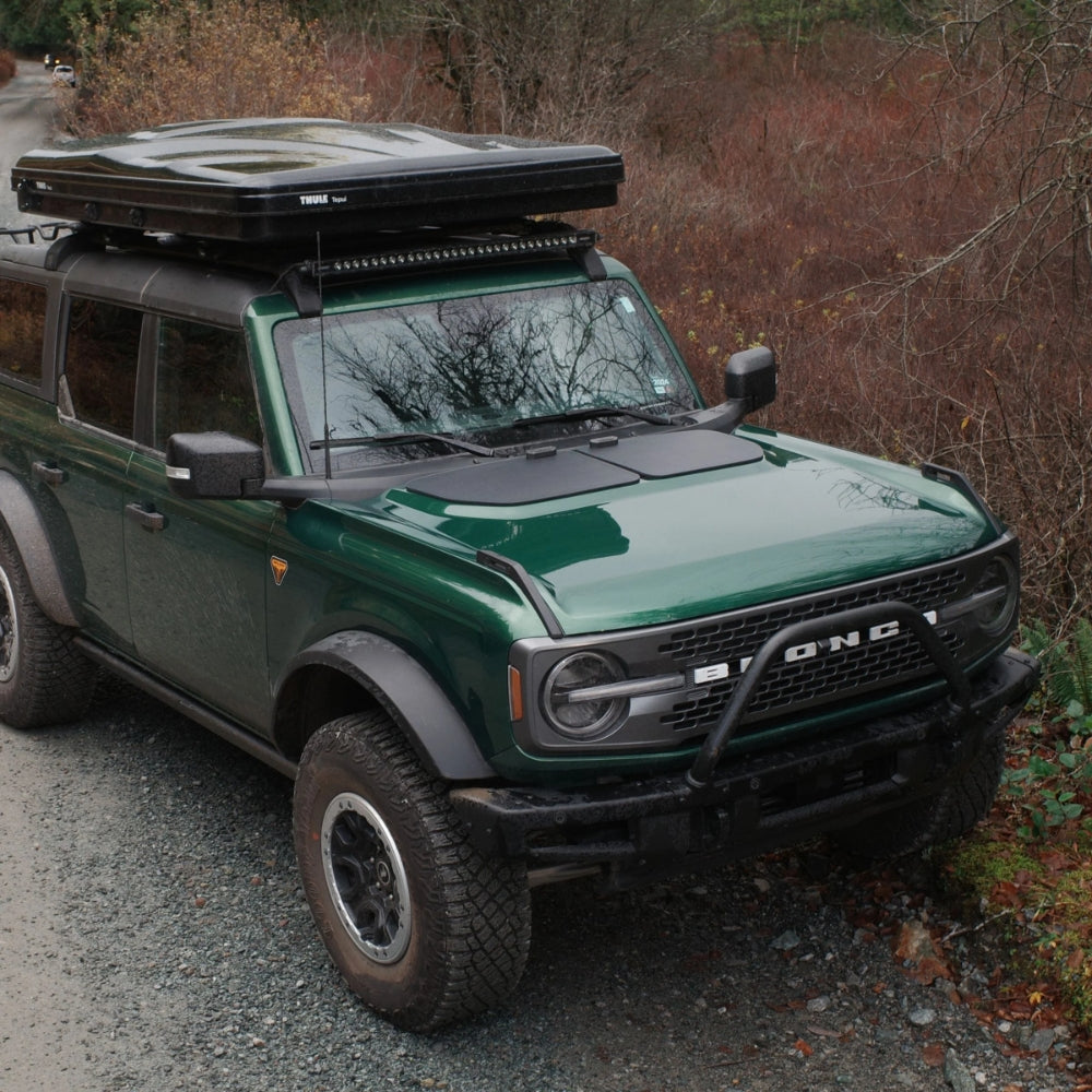 A Green Ford bronco complete with Cascadia 4x4 VSS Hood solar and thule roof top tent.